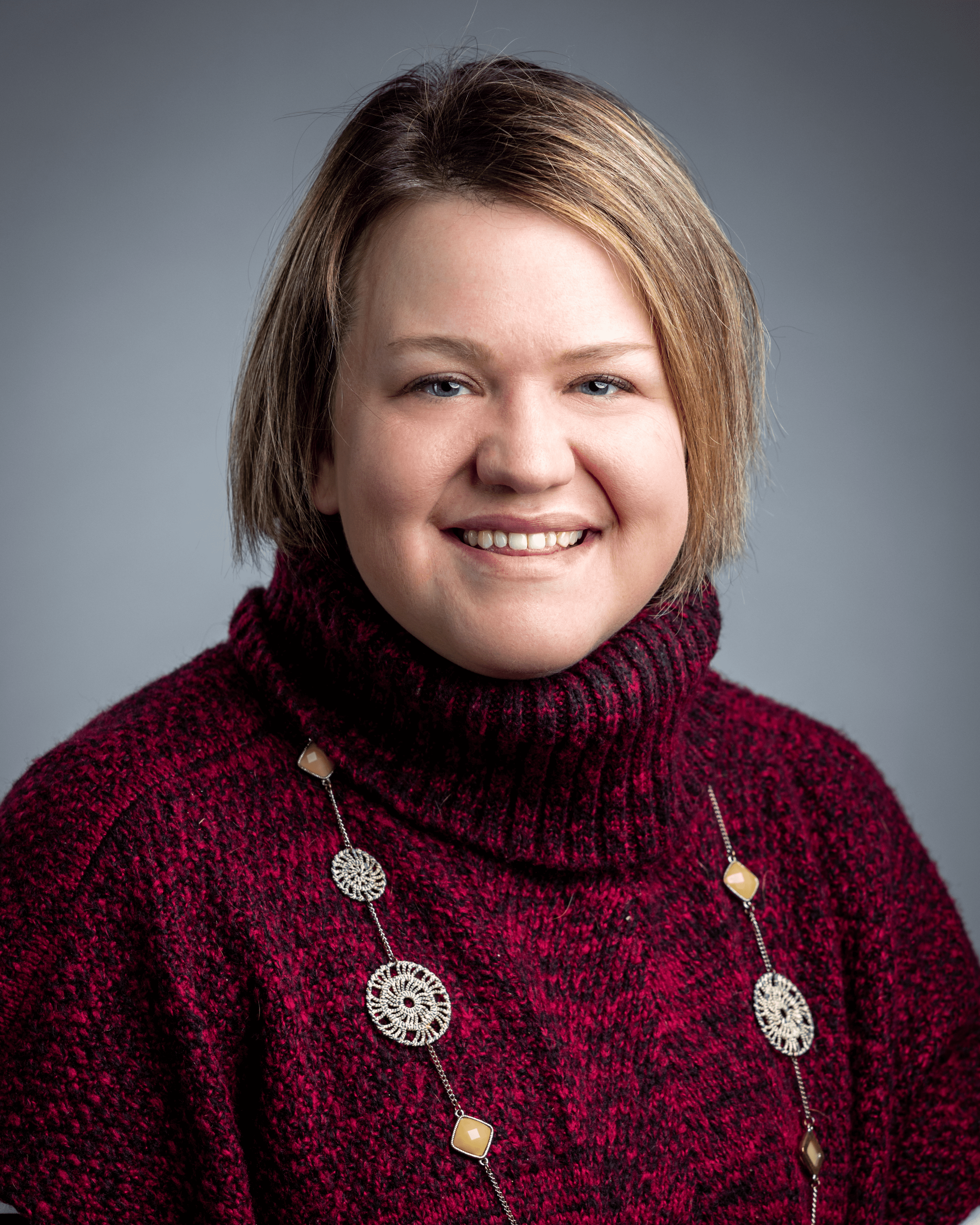 jenniffer McComas in Red Sweater and Necklace Headshot